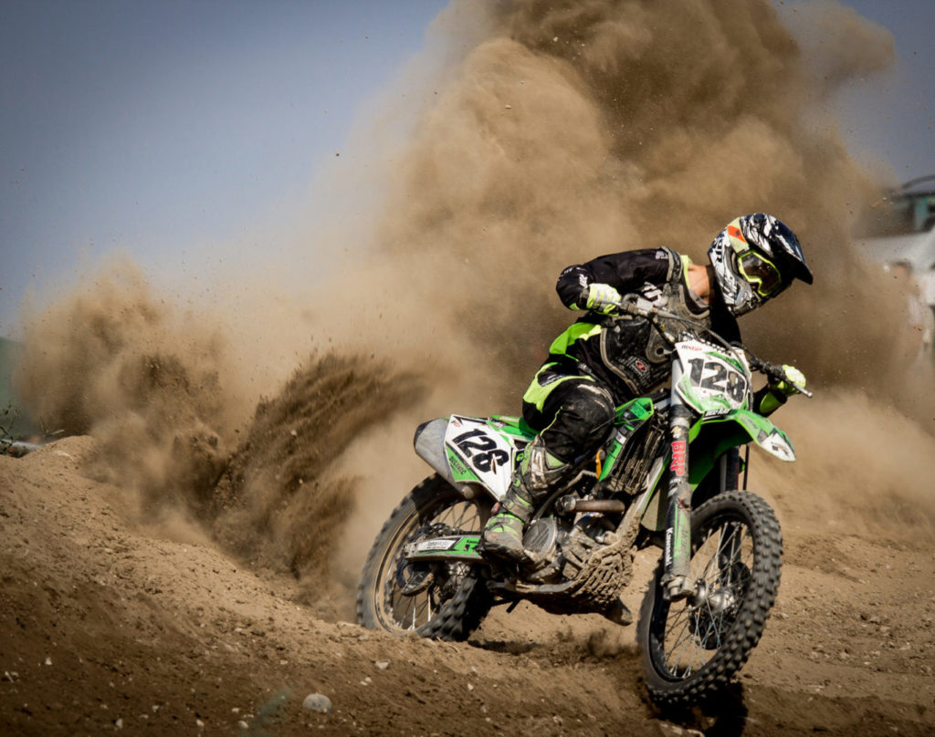 Canva - Rider Riding Green Motocross Dirt Bike